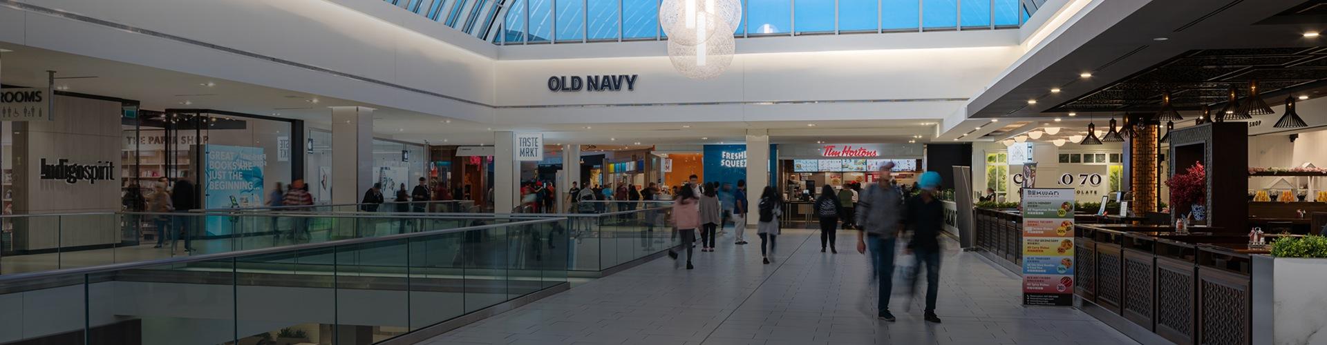 Indoor mall walkway featuring shops, dining options, and convenient visitor amenities