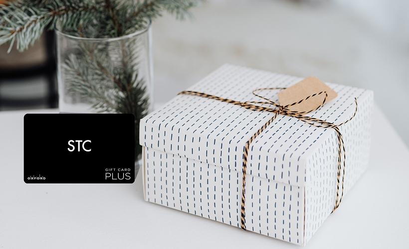 Gift card ordered online with home delivery, shown in wrapped gift packaging ready to give