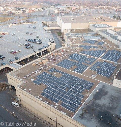Aerial view of rooftop solar panels at a shopping centre supporting sustainability and clean energy