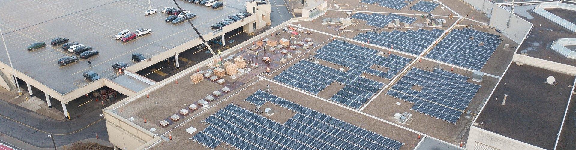 Aerial view of rooftop solar panels at a shopping centre supporting sustainability and clean energy