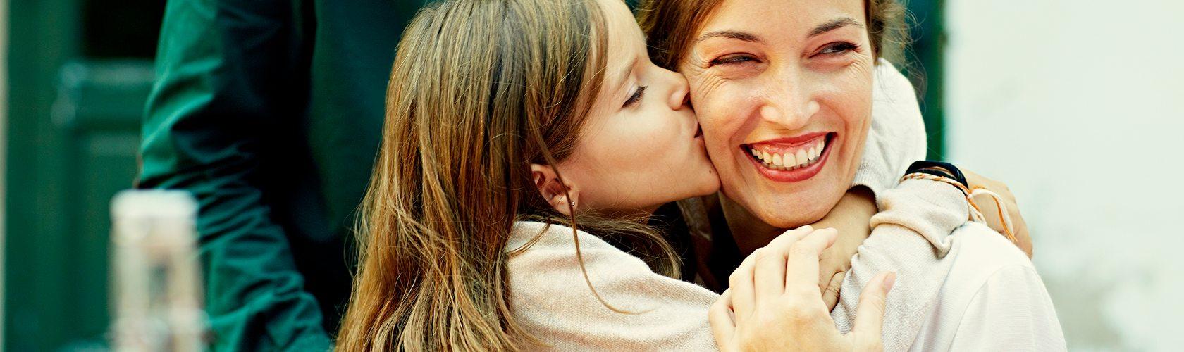 Mother and child sharing a joyful moment together during a gift card shopping experience