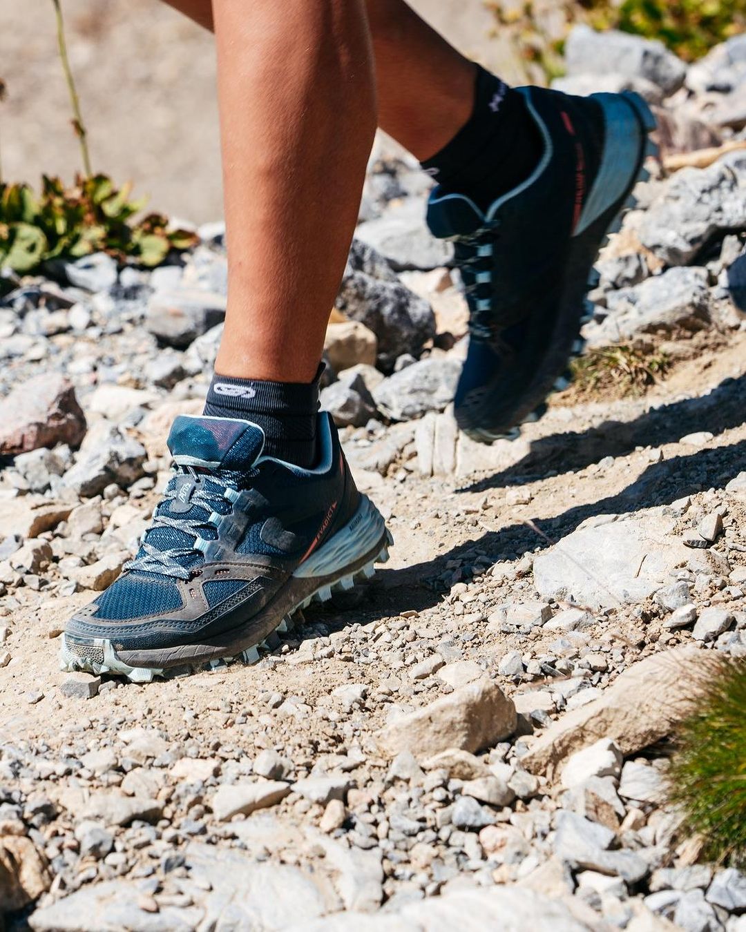 Close-up image of a person wearing hiking shoes on a trail