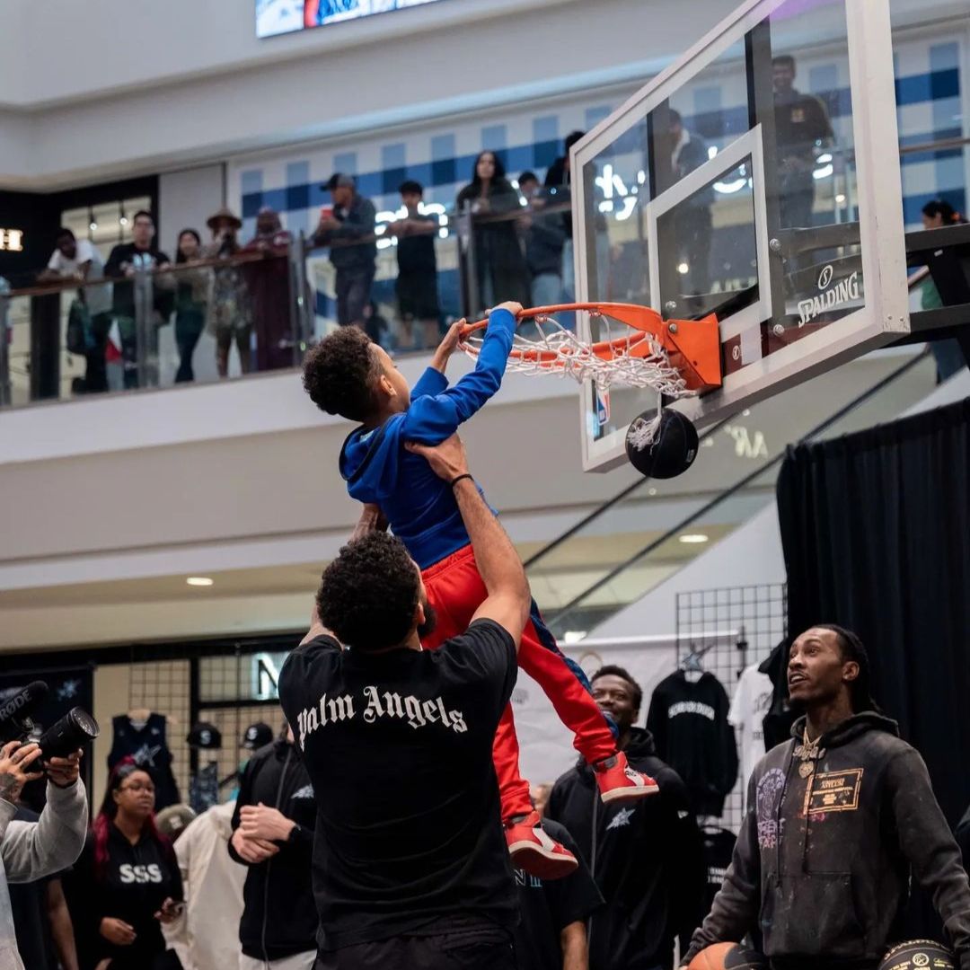 a child making a slam dunk