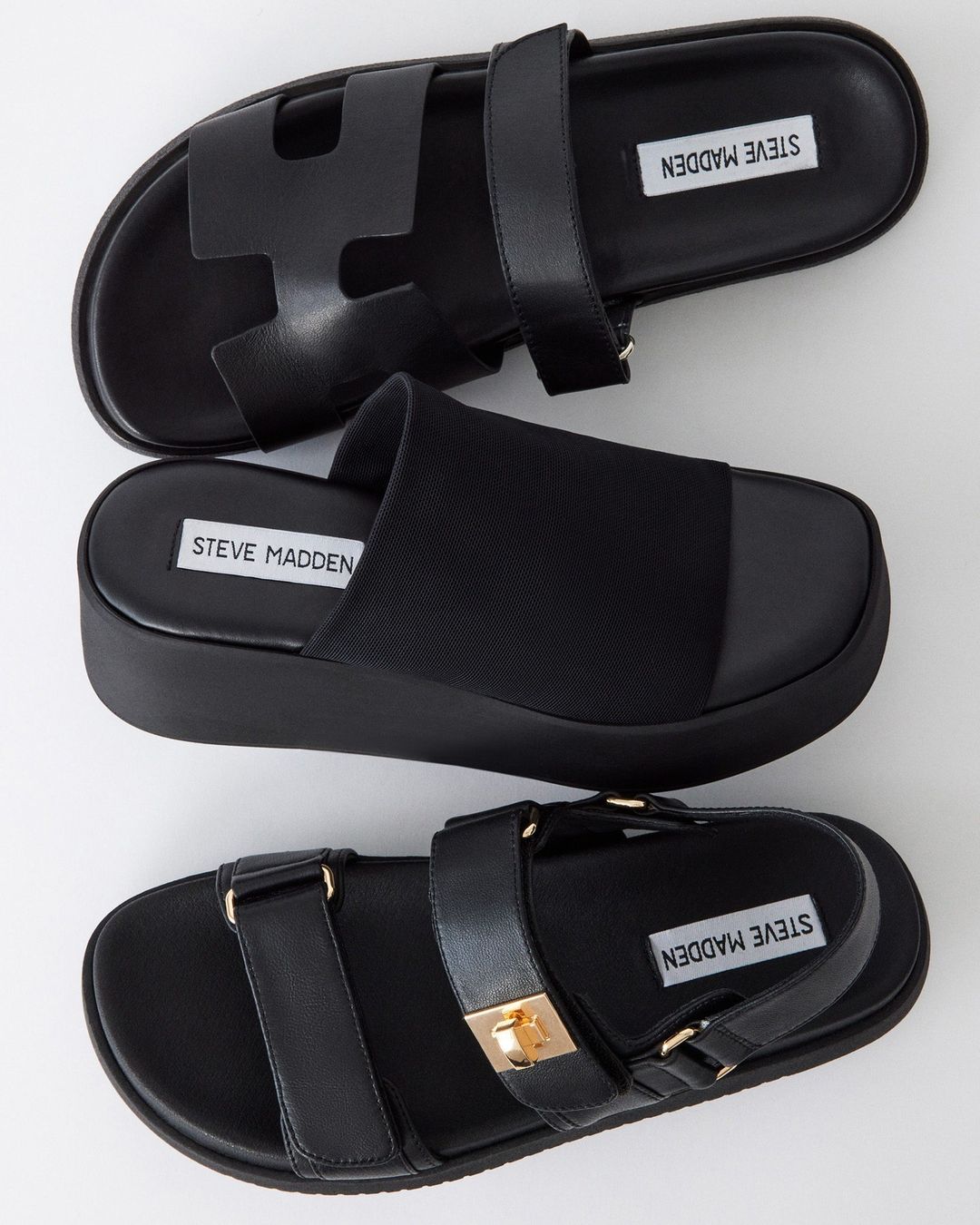 Three different styles of black sandals.