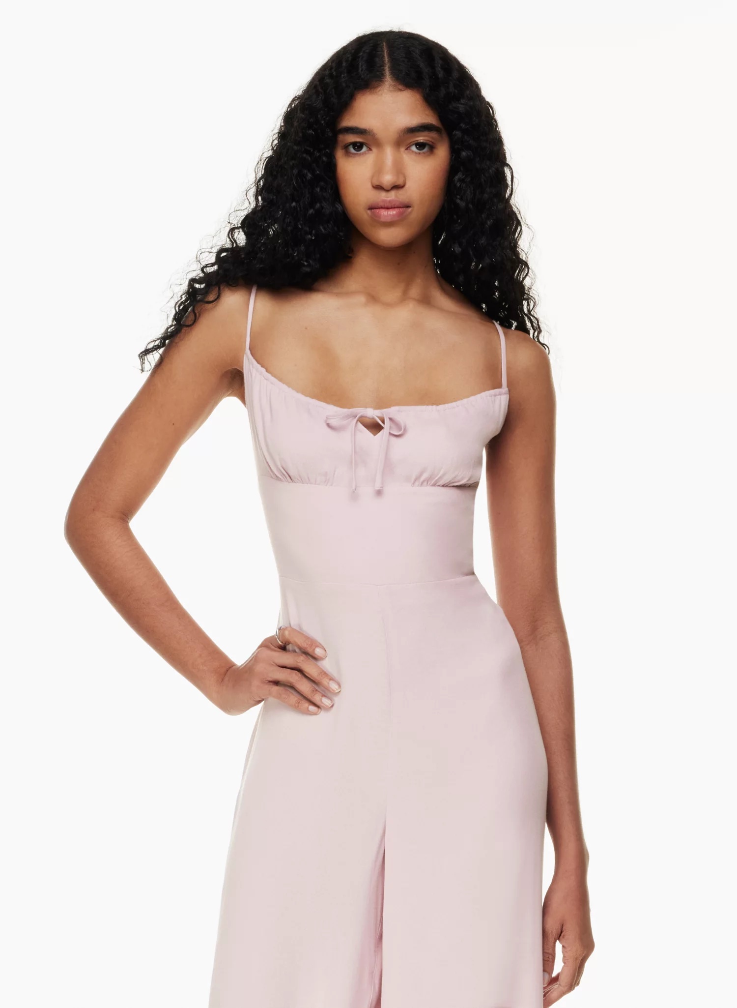 image of a model wearing a spaghetti strap light pink jumpsuit