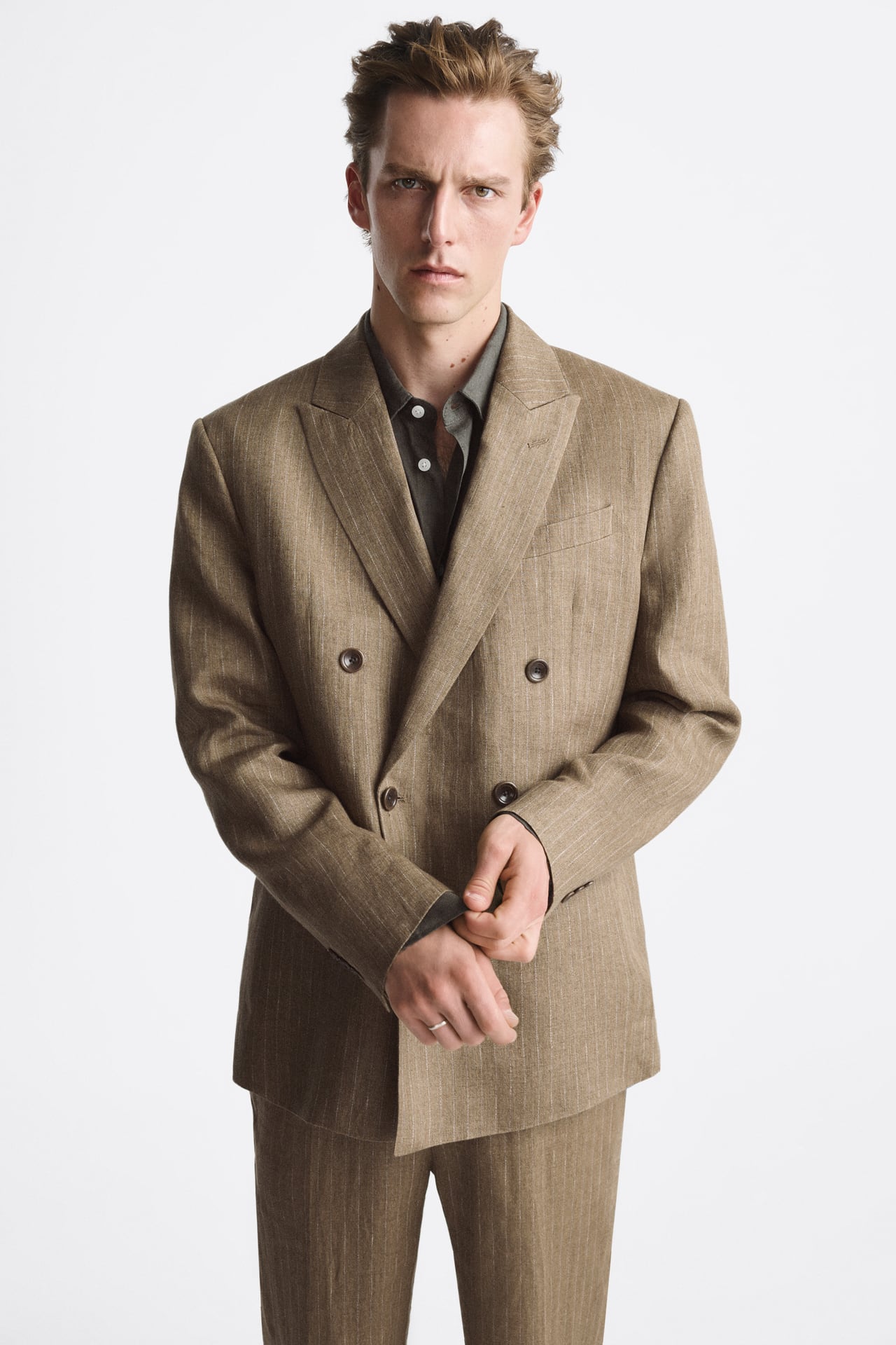 Image of a man wearing a light brown suit