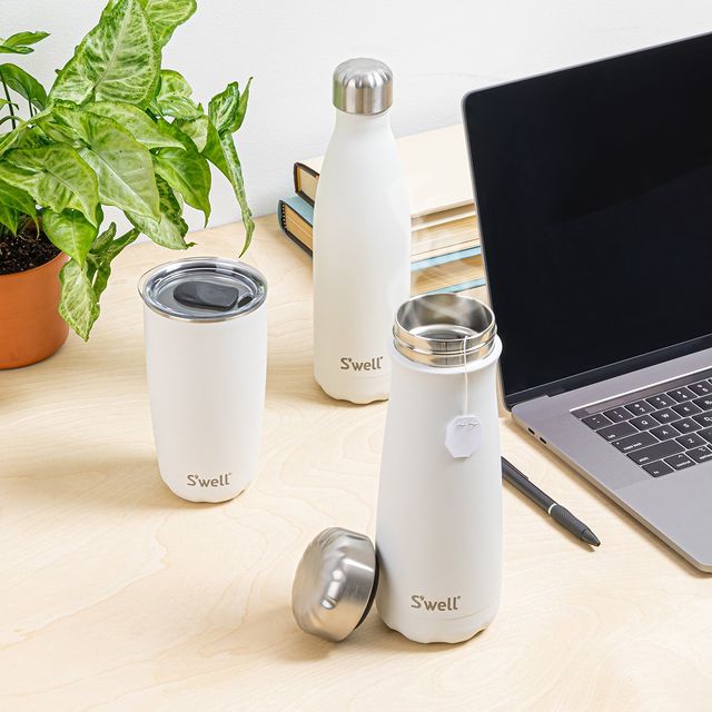 image of three swell products on a desk beside a laptop