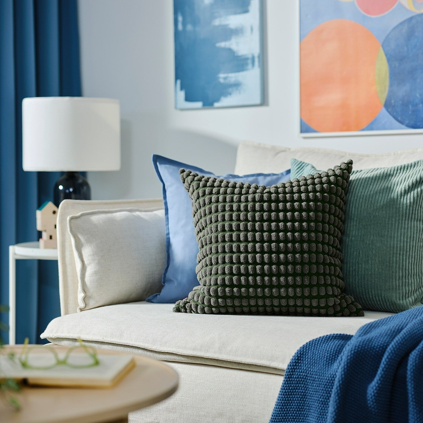 green cushion cover on a couch in a living room