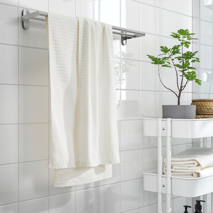 close up of a white towel hanging on a towel rack in a bathroom