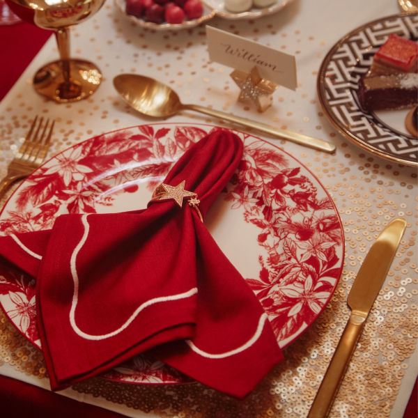 A beautifully arranged table with red and gold decorations, creating an elegant and festive ambiance.