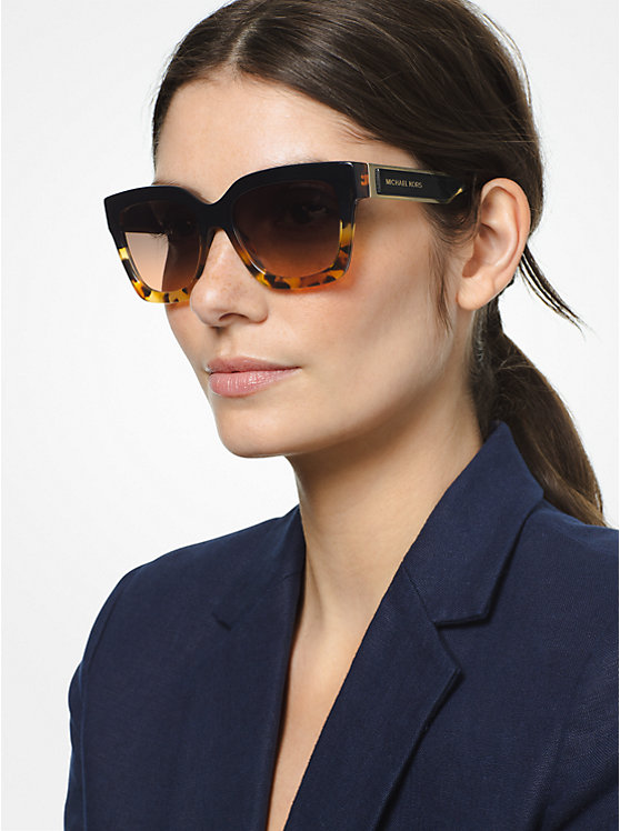 Woman modelling large tortoise framed sunglasses