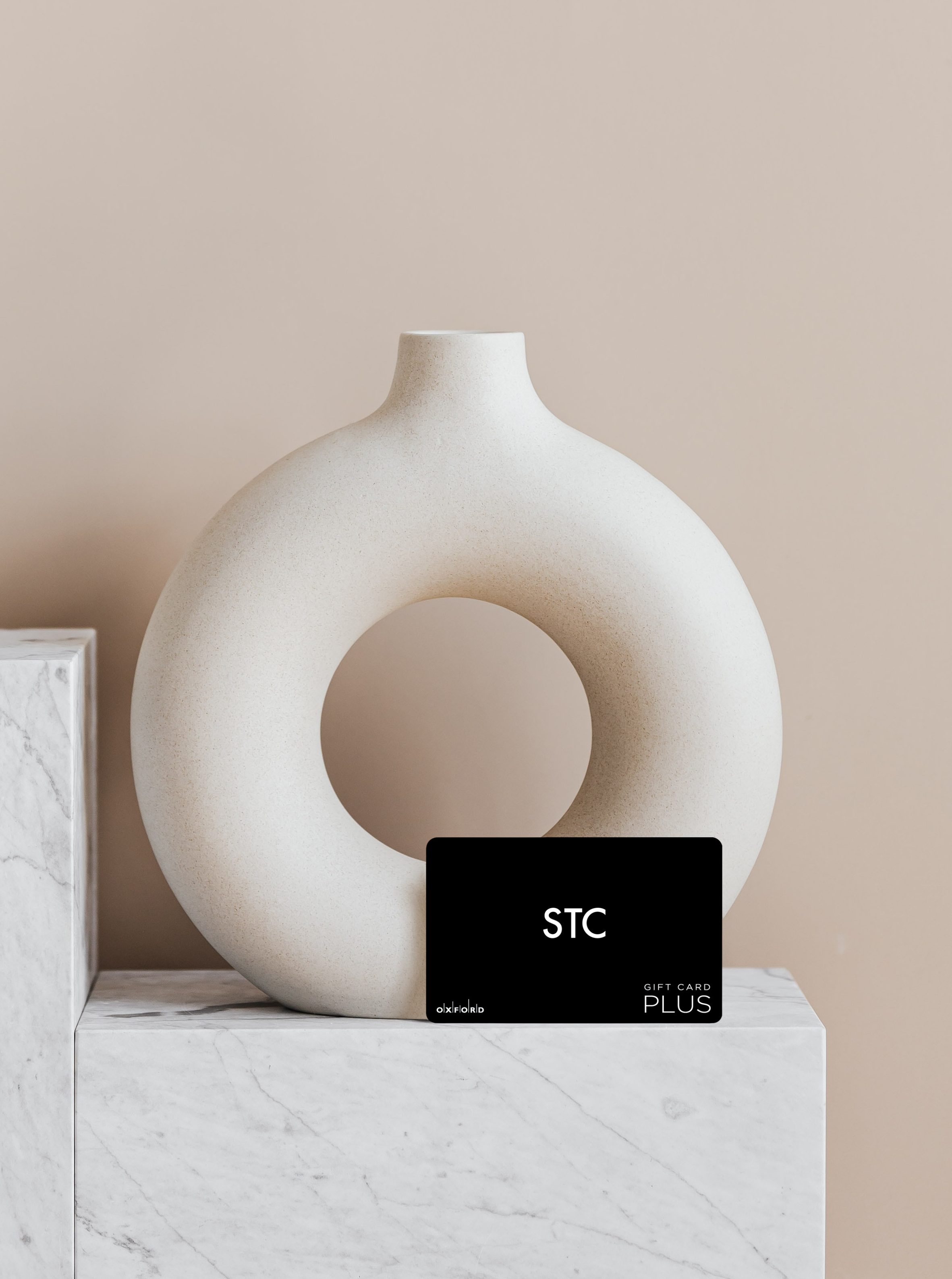 promotional image of a STC gift card in front of a vase