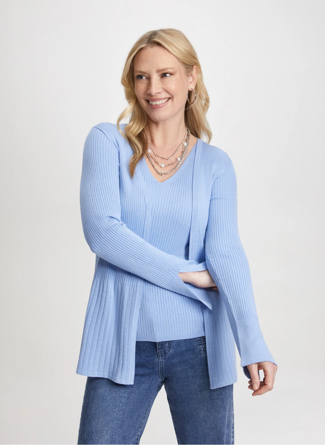 model wearing a blue knit cardigan and sweater