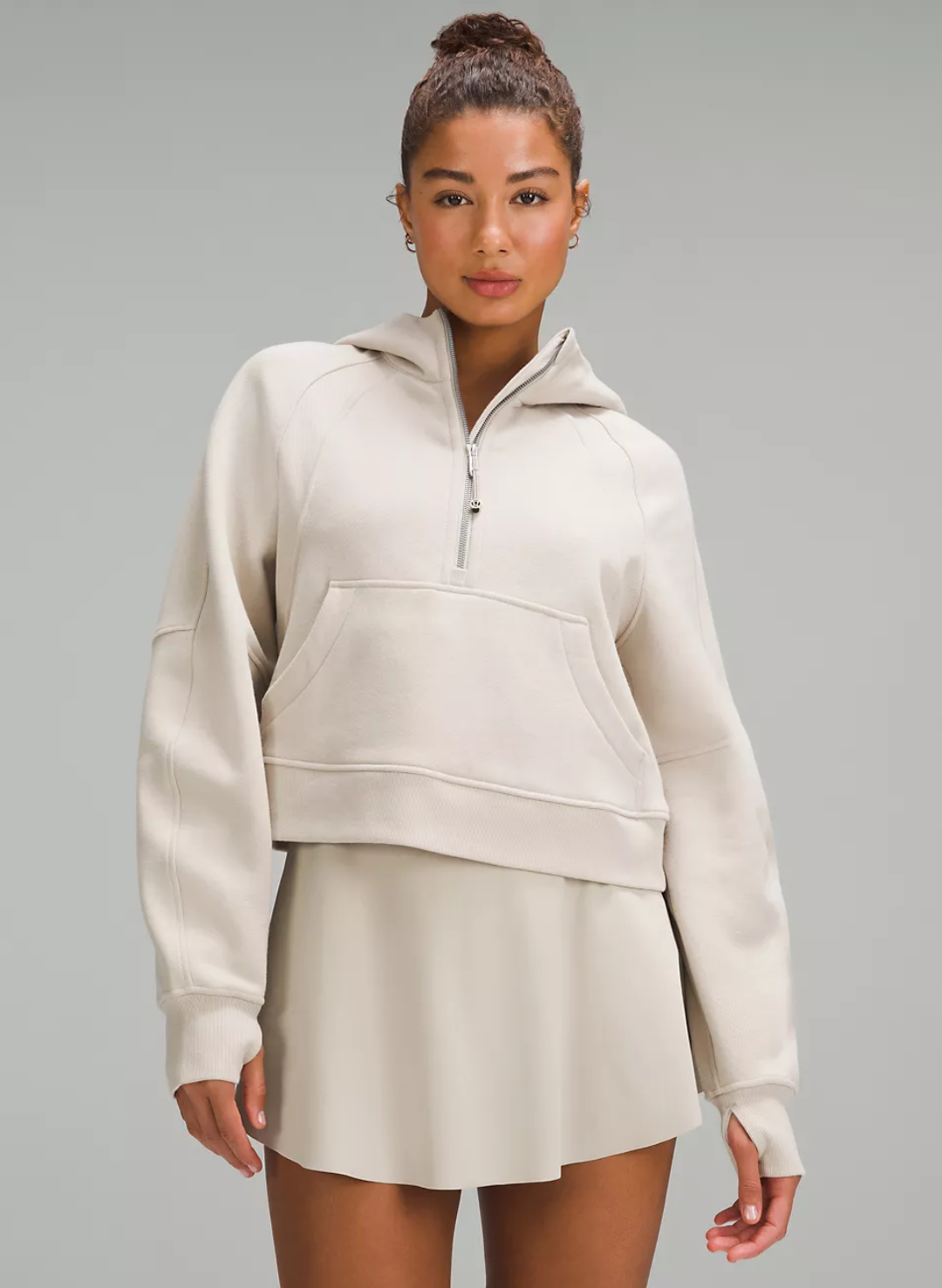 woman wearing a neutral half zip hoodie