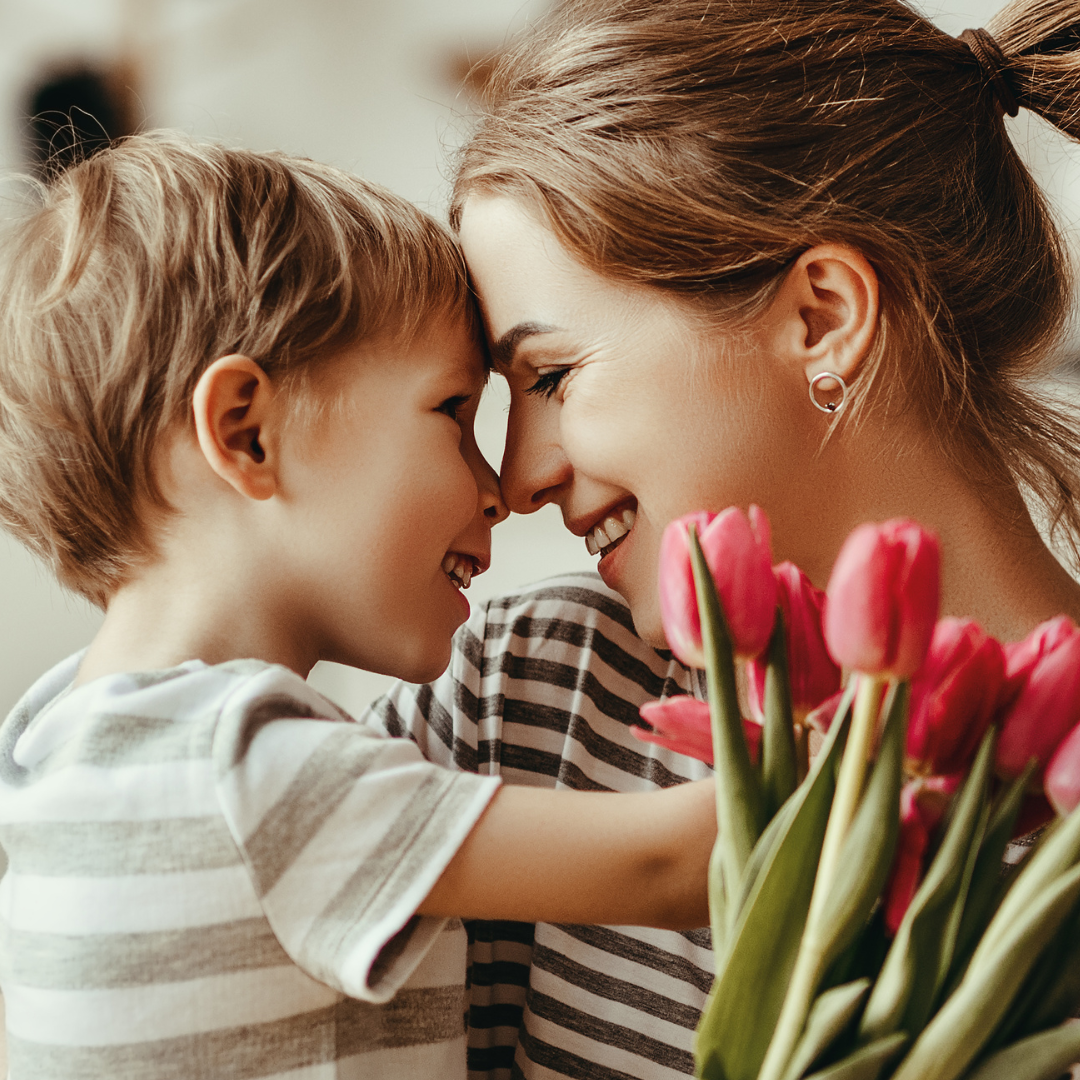 Mother and son hugging with tulips