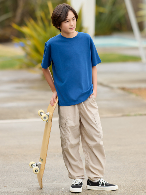 boy modelling in casual streetwear with skateboard
