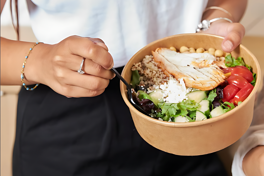 woman eating a cultures salad bowl