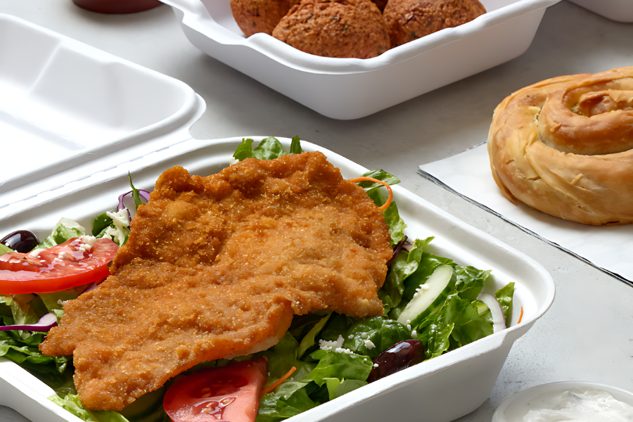 chicken cutlet on salad with falafels and roll