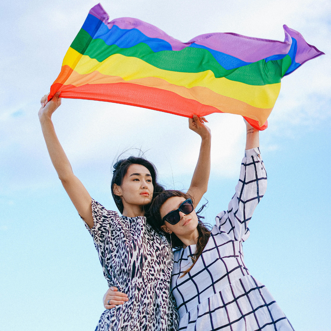 2 women holding a pride flag