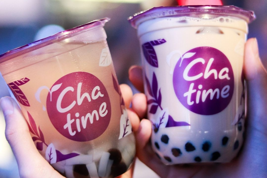 a person holding 2 chatime drinks