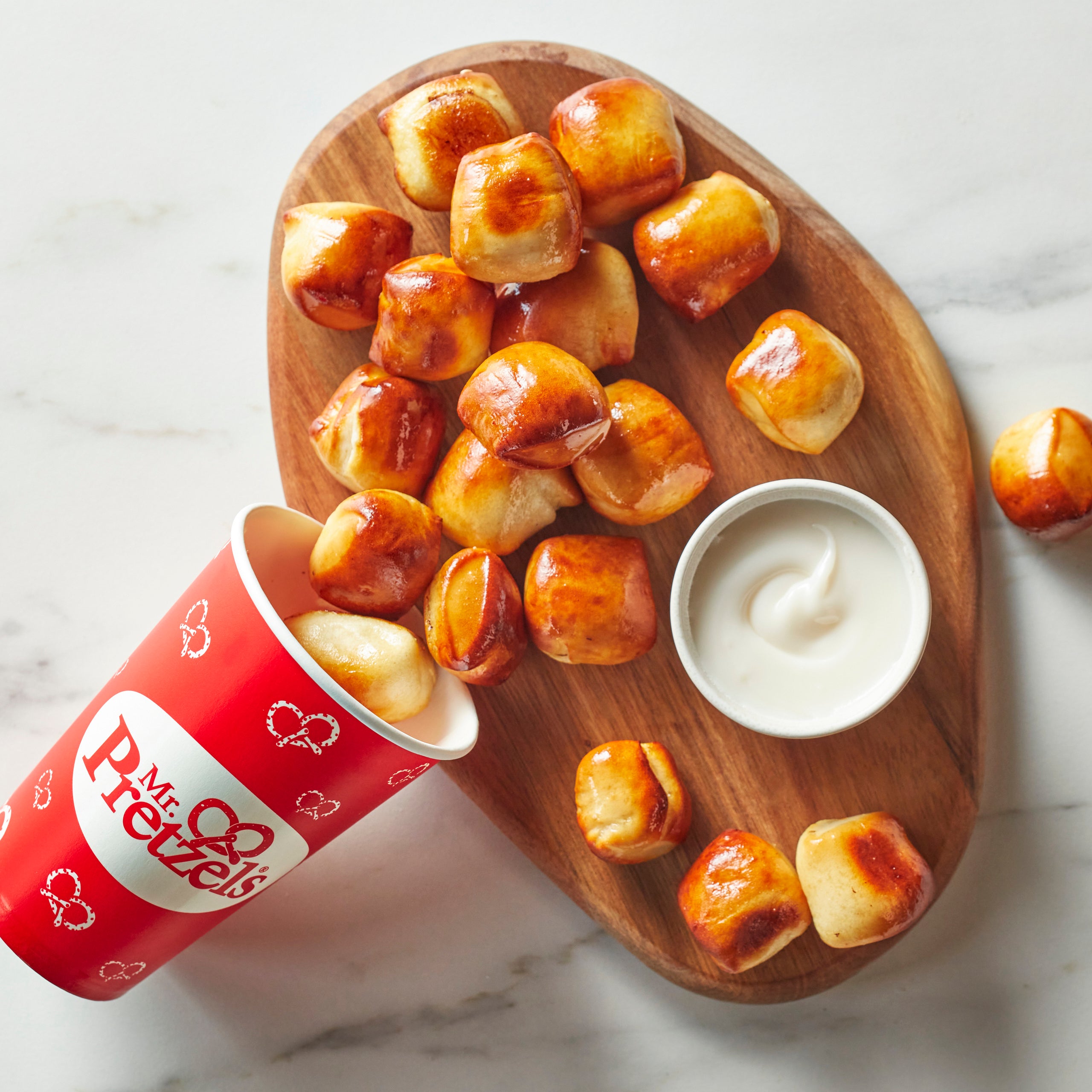 mr. pretzel bites on board with cream cheese