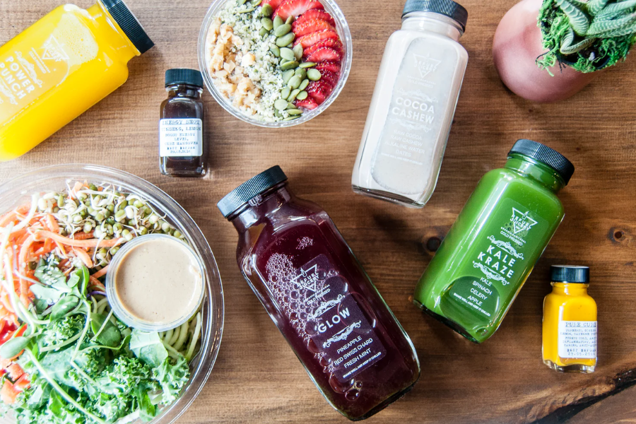 assortment of bottled juice and salad