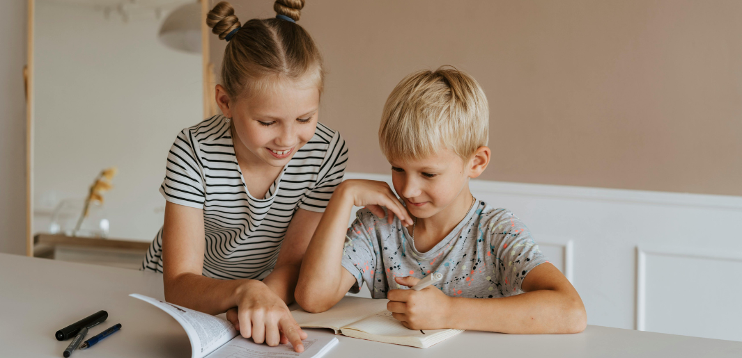 sister helping brother with homework