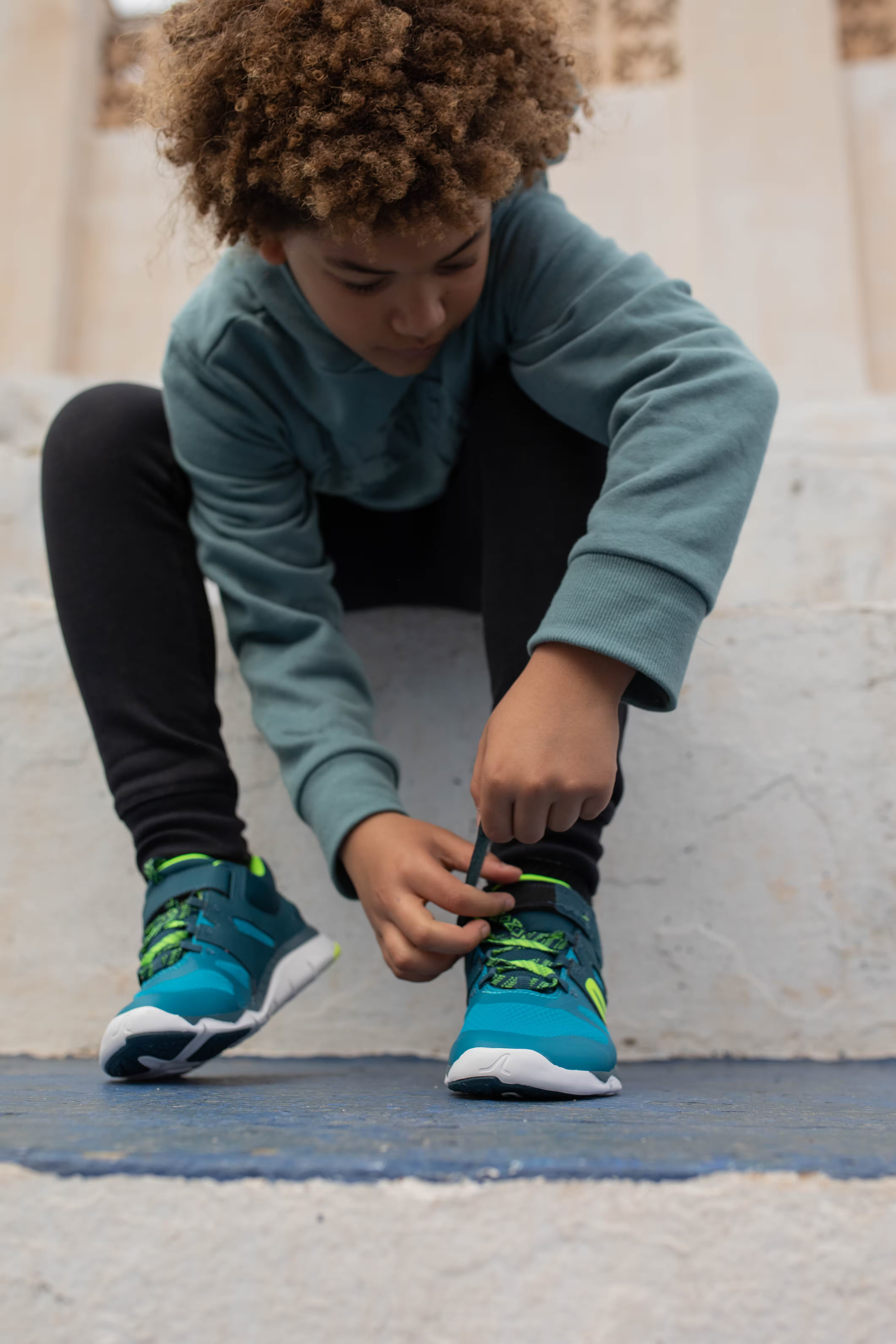 boy putting on his running shoes