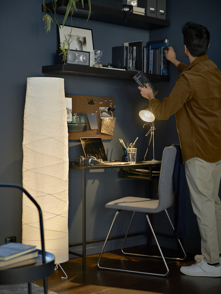 man organizing home office shelf