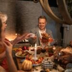 family eating together happily during thanksgiving