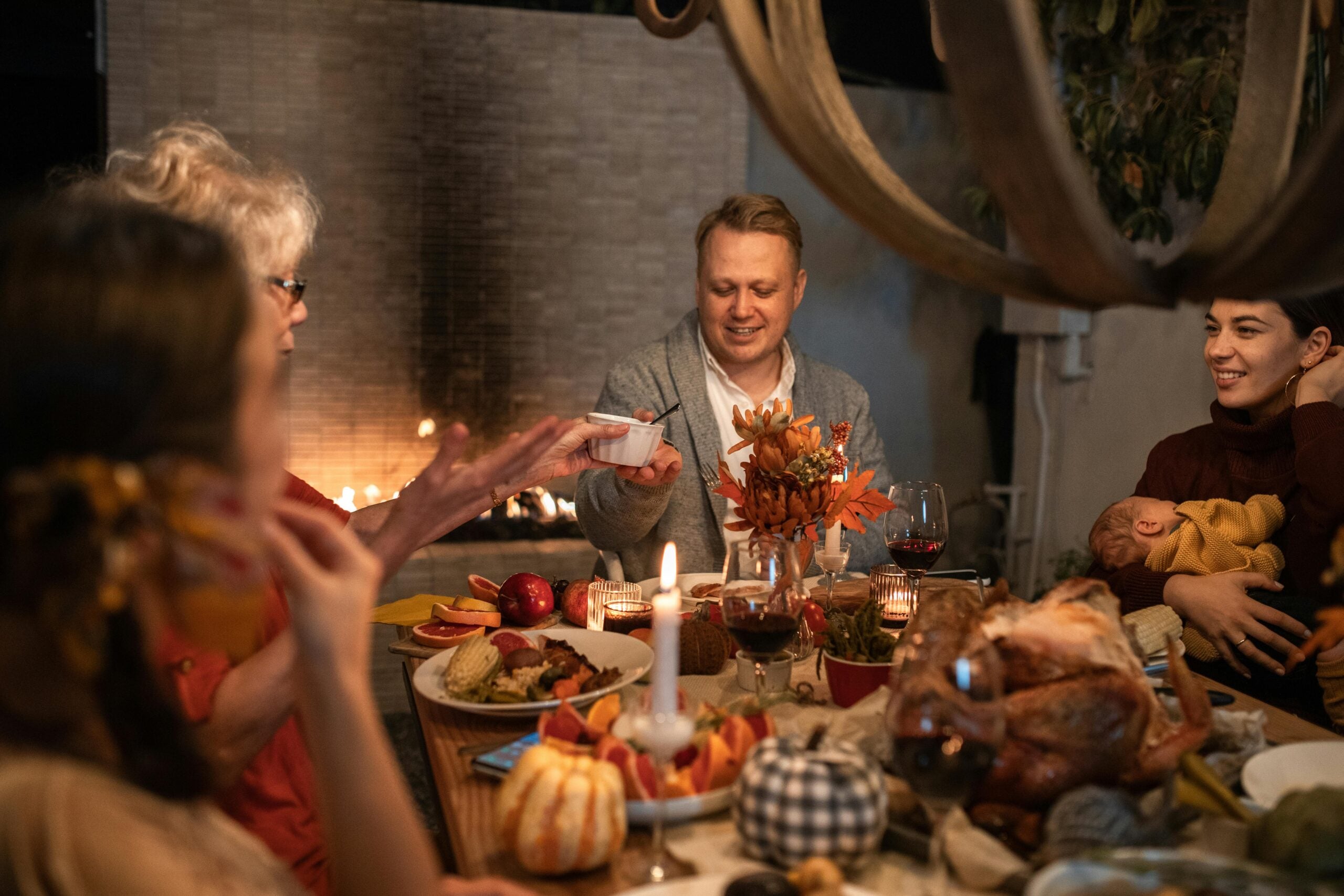 family eating together happily during thanksgiving