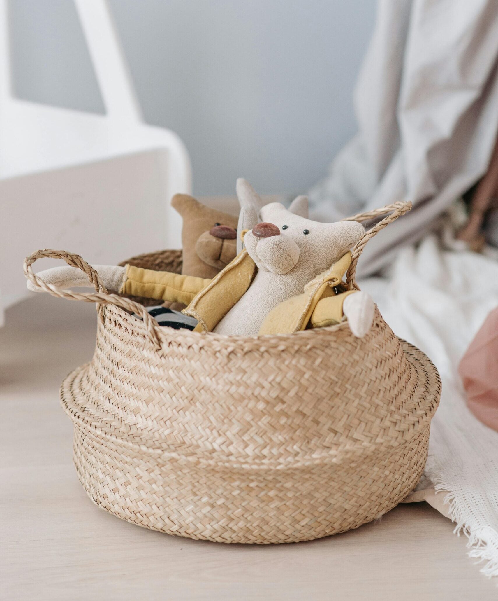 A wicker basket holding toy animals.