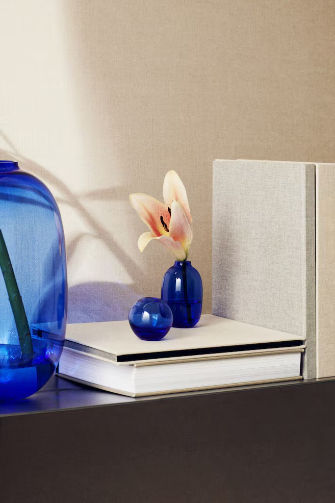 Blue vases sitting on a white shelf