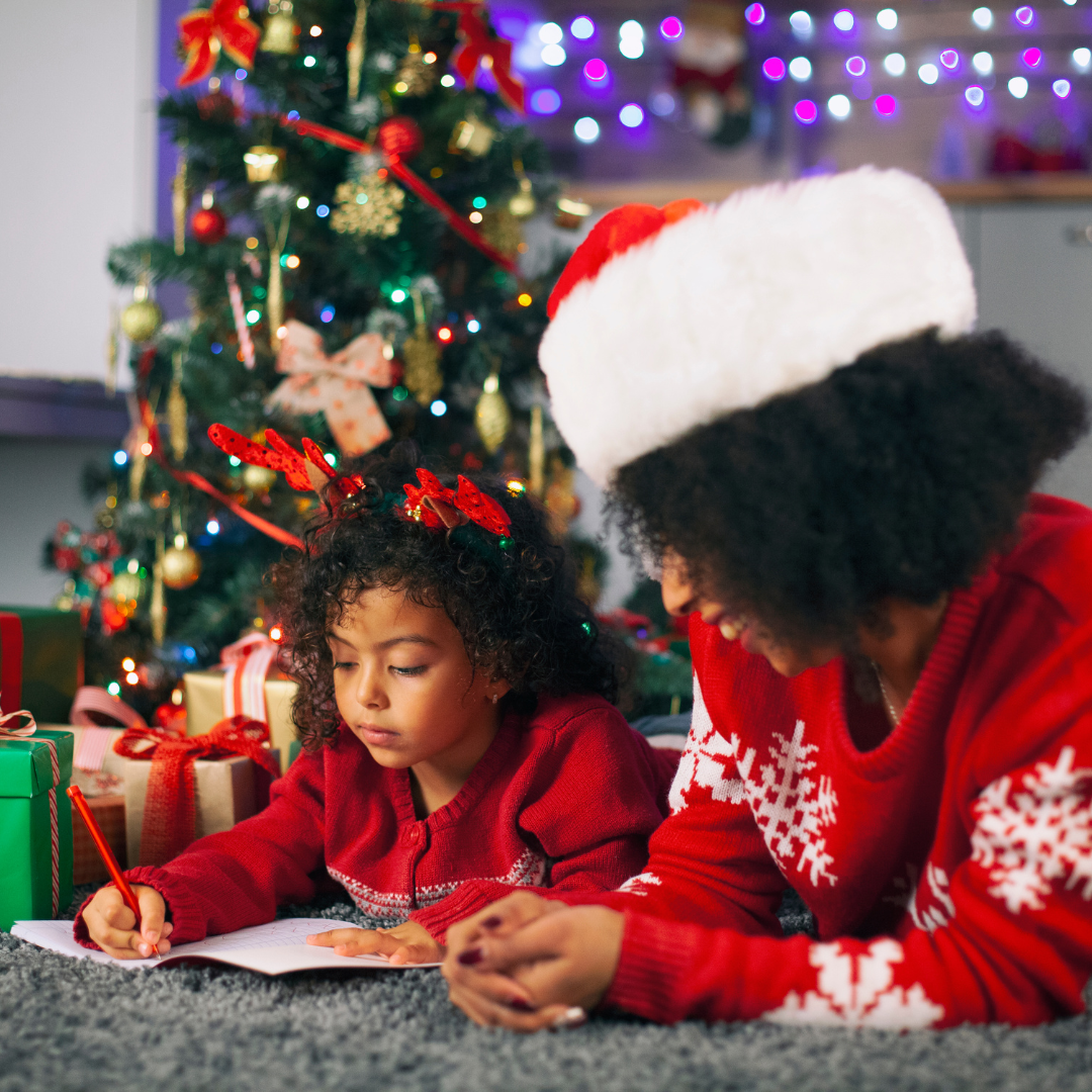 a mom and girl writing a letter to santa