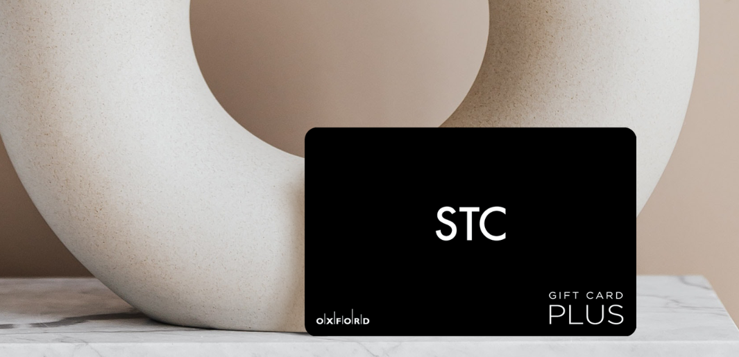 STC gift card leaning on neutral vase