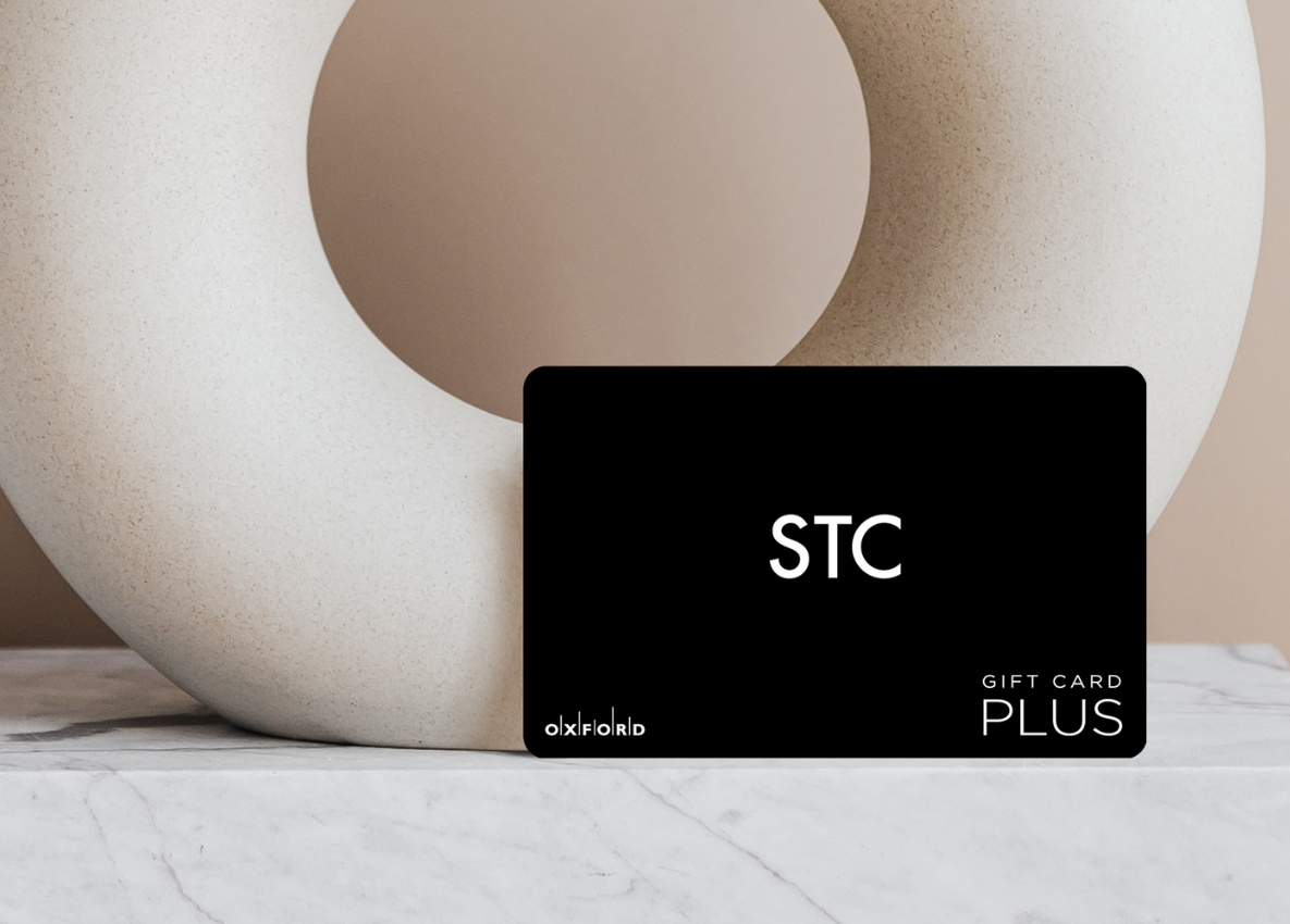 STC gift card leaning on neutral vase