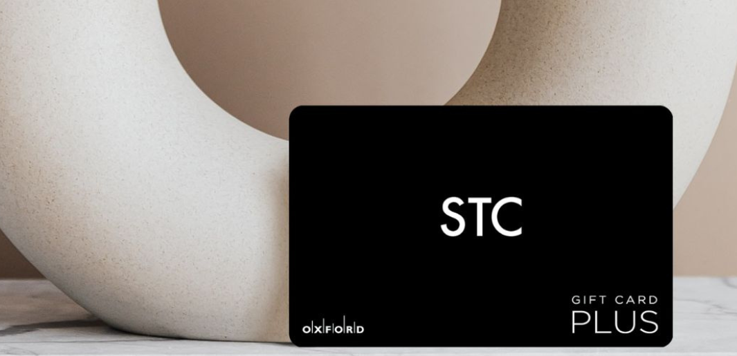 STC gift card in front of round vase