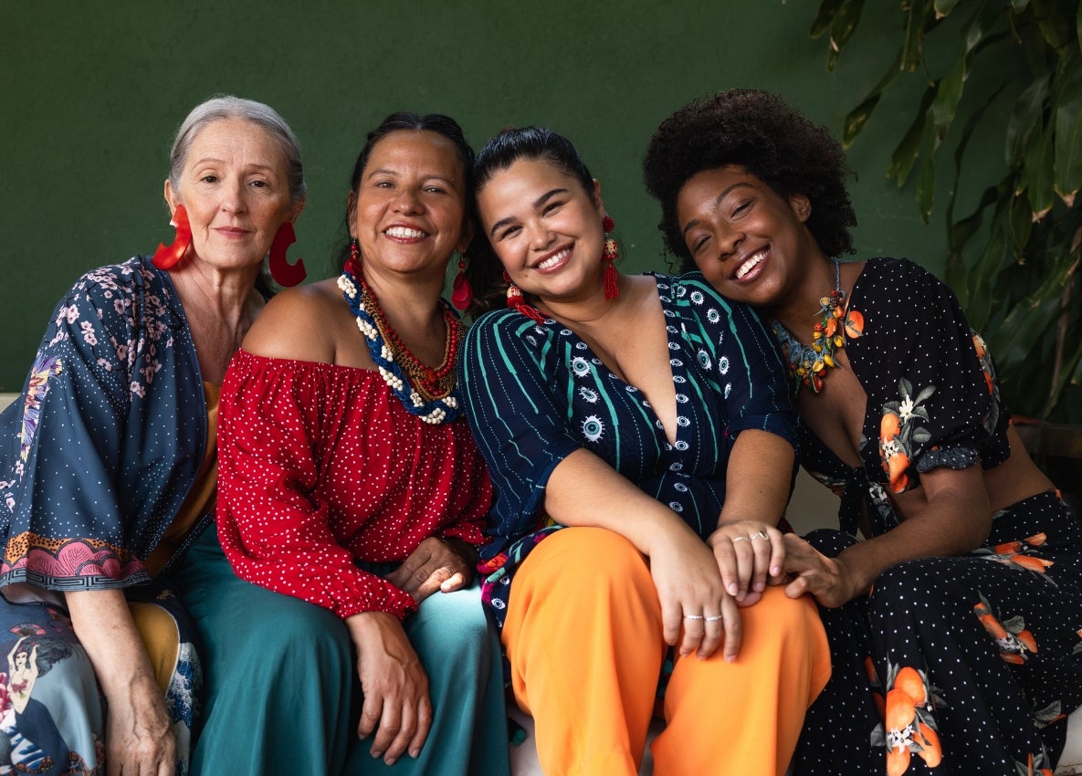 a group of women sitting together and smiling