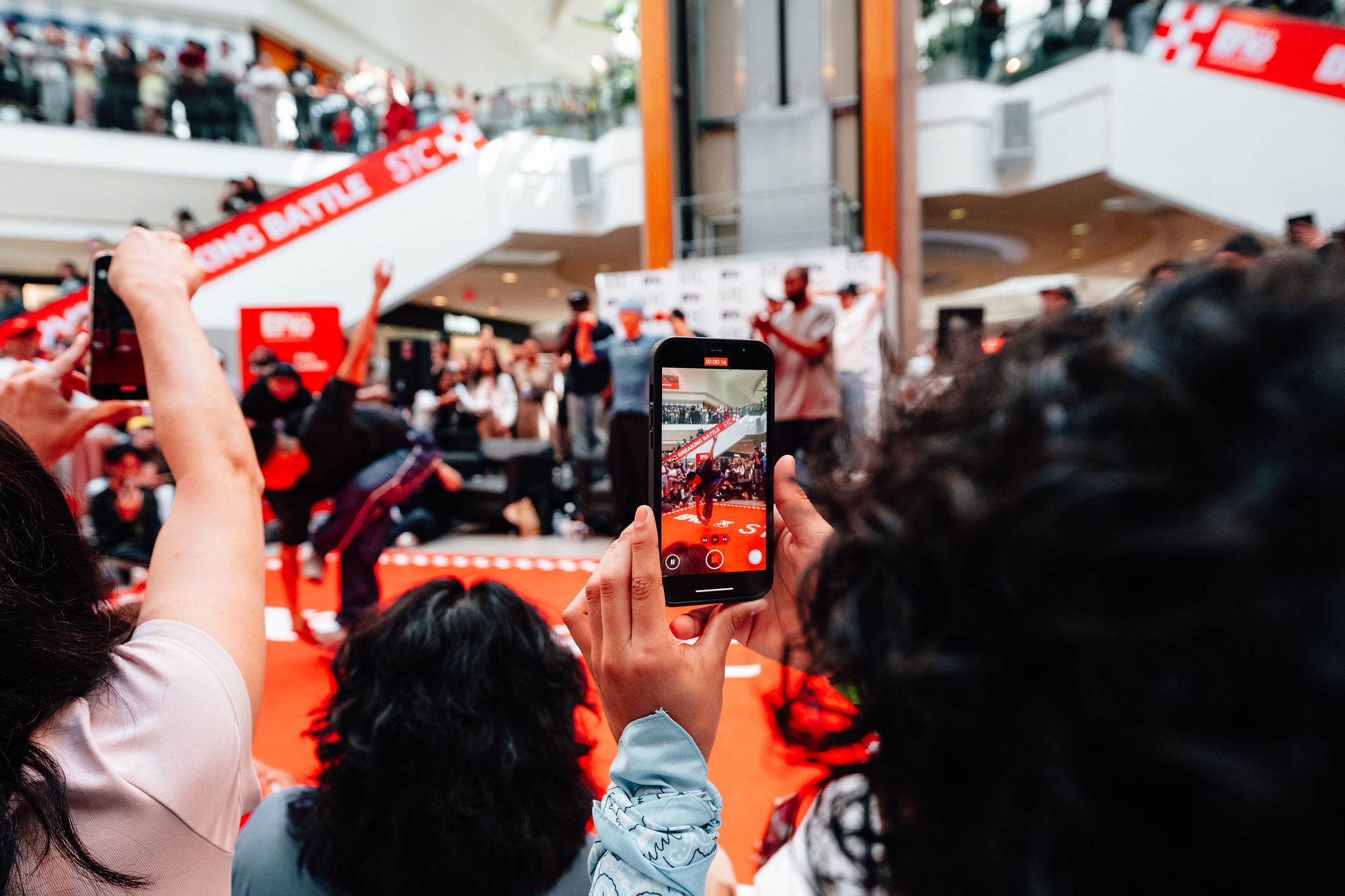 a person recording the breakdancing competition