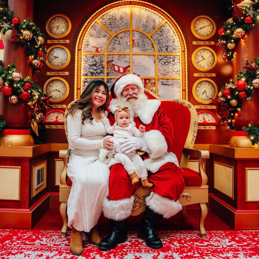 mom and baby taking picture with santa