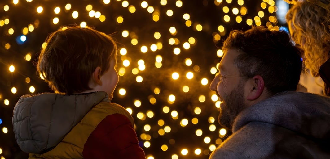 kid with dad at tree lighting ceremony