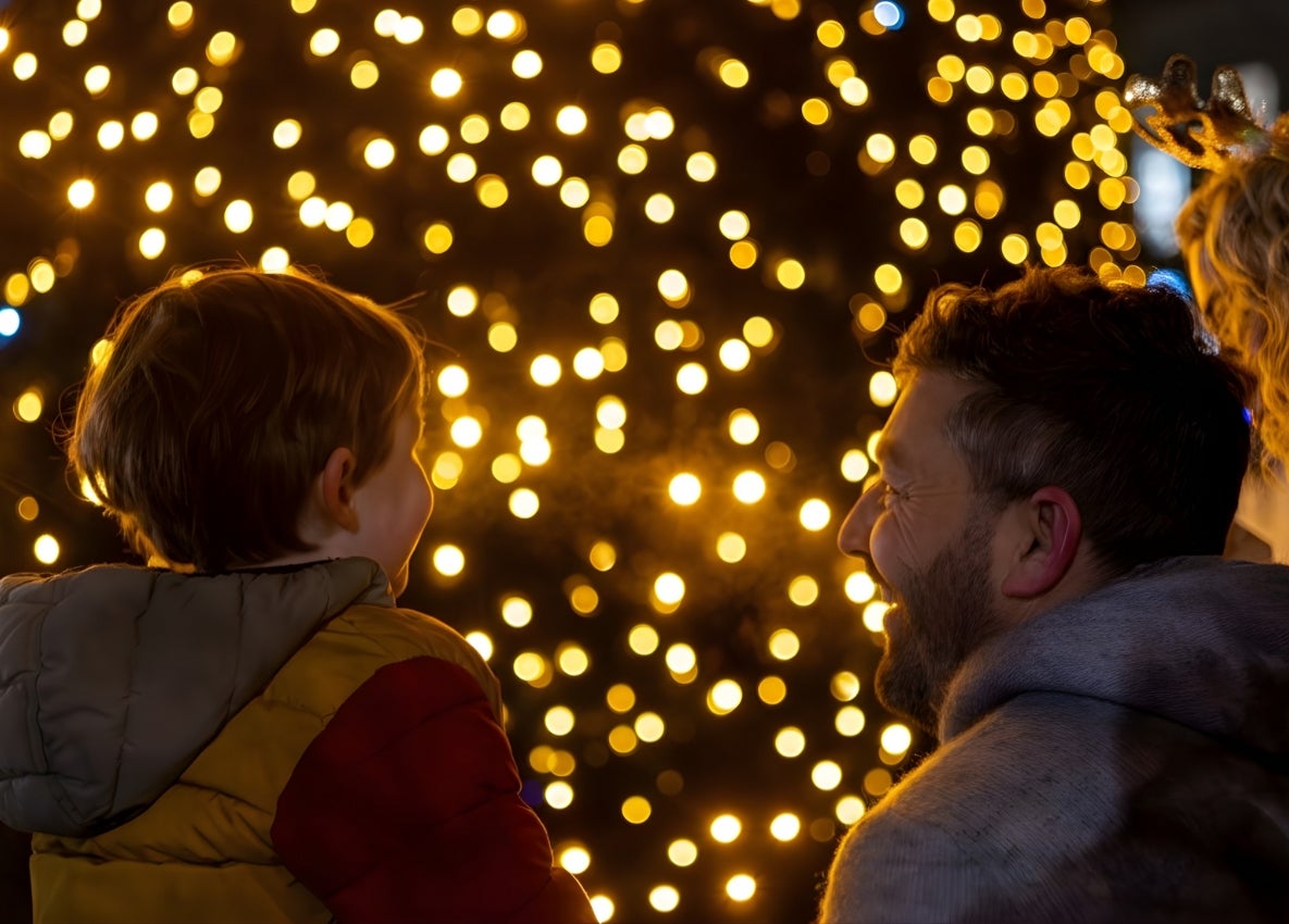 kid with dad at tree lighting ceremony