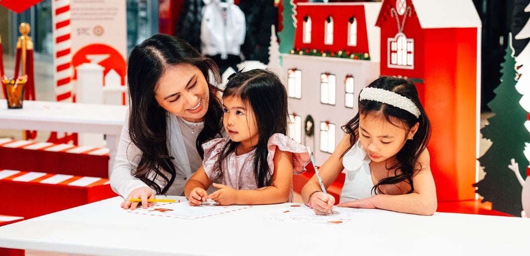 mom with children writing letters to santa